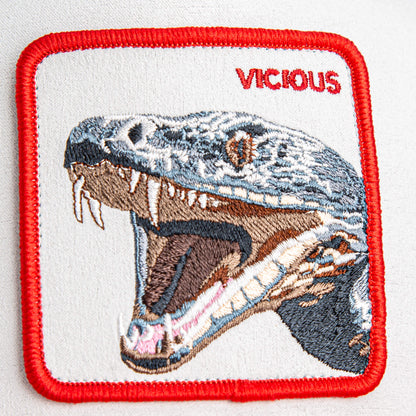 The Goorin Bros. Suede Snake patch features an open-mouthed, snarling snake and the word "VICIOUS" in bold red—smooth to the touch and ideal for customizing your premium trucker hat.