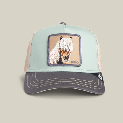 The Goorin Bros. Tricolor Horse is a two-tone trucker hat featuring an embroidered horse with long hair over its eyes—ideal for fans of the fringe horse hat trend.