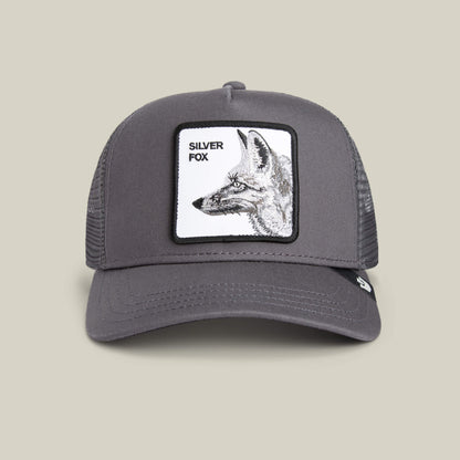 The Goorin Bros. Silver Foxxx is a stylish gray trucker hat with a mesh back, featuring a front patch with a black and white fox illustration and "Silver Foxxx" text—perfect for adding sophistication to any outfit.