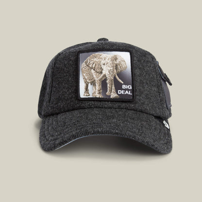The Goorin Bros. "Kind of" baseball cap in OIL features a patch with an elephant and "BIG DEAL" on the front, set against a light beige background for a standout, feel-estate vibe.