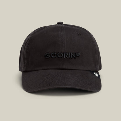 The Papa Core hat by Goorin Bros. is a black curved brim style with a soft crown and "GOORIN" embroidered in black on the front, shown against a plain beige background.