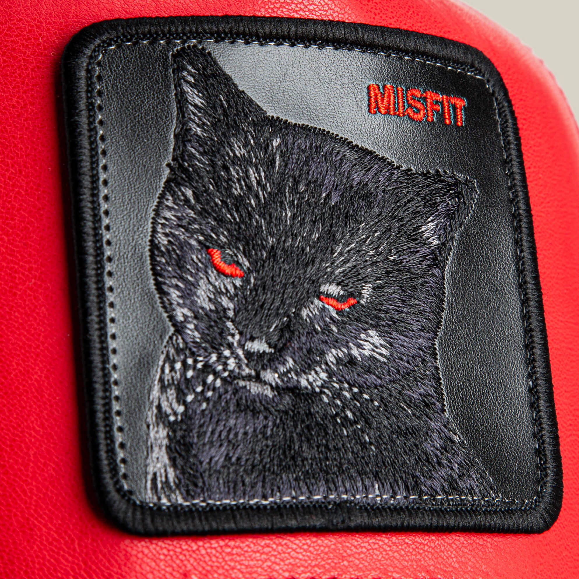 Add bold style to your red faux leather hat with the Courtside Misfit patch by Goorin Bros.—a black cat with red eyes and "MISFIT" embroidered on striking red fabric. Show off your unique vibe with this standout accessory!.