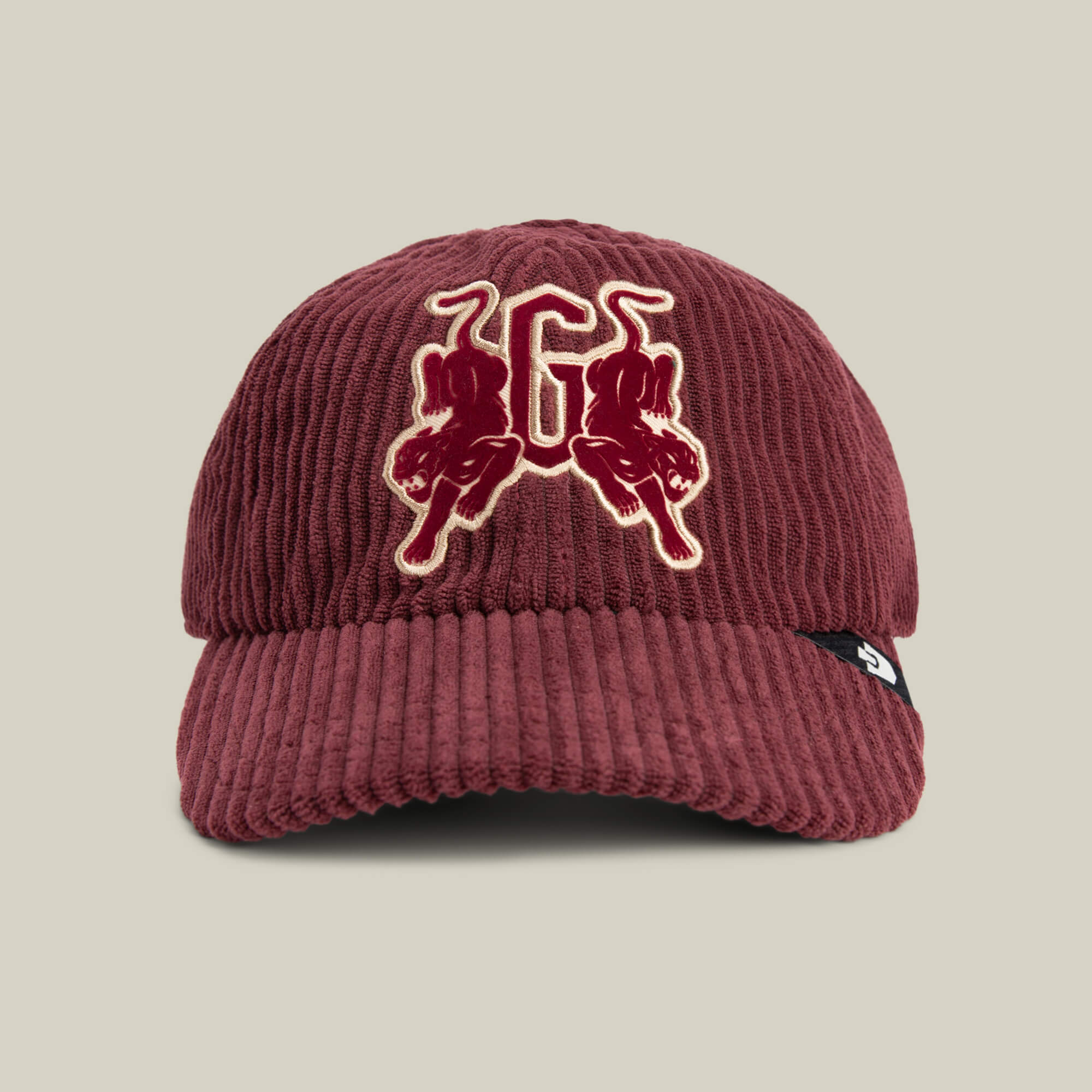A burgundy Goorin Bros. Bleacher Report cap featuring a corduroy crown, embroidered letter G with two bulls on the front, and a black side tag with a white logo.