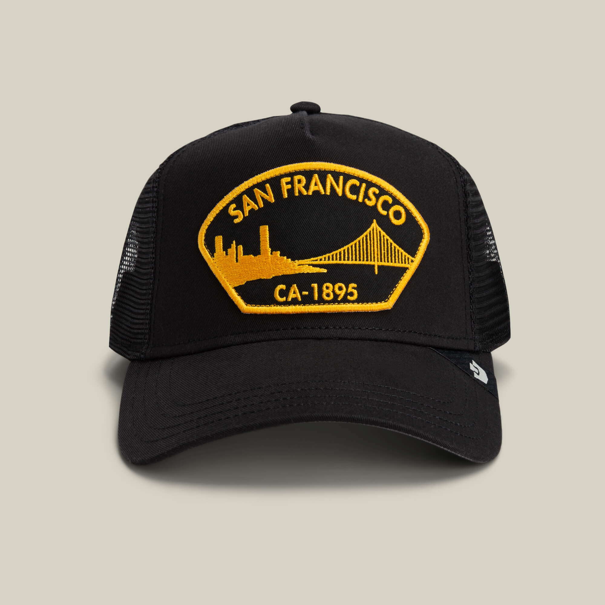 The Goorin Bros. San Francisco hat in VOID features a yellow patch reading "San Francisco CA-1895" with a skyline and bridge design on the front.