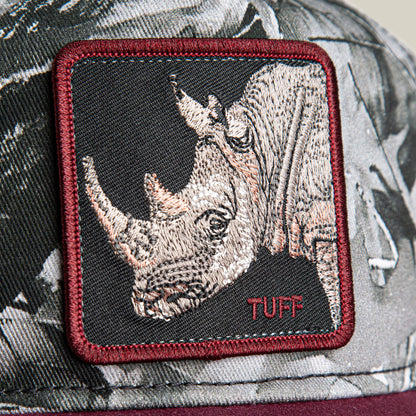 Close-up of a fabric patch on a low crown Goorin Bros. Tuff Camo hat, featuring an embroidered rhinoceros head and the word "TUFF" in red.
