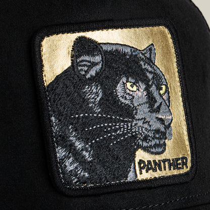 A close-up of Goorin Bros. Golden Panther patch, showing a black panther with yellow eyes and "PANTHER" on gold, sewn onto a stealth hat with a microsuede crown.