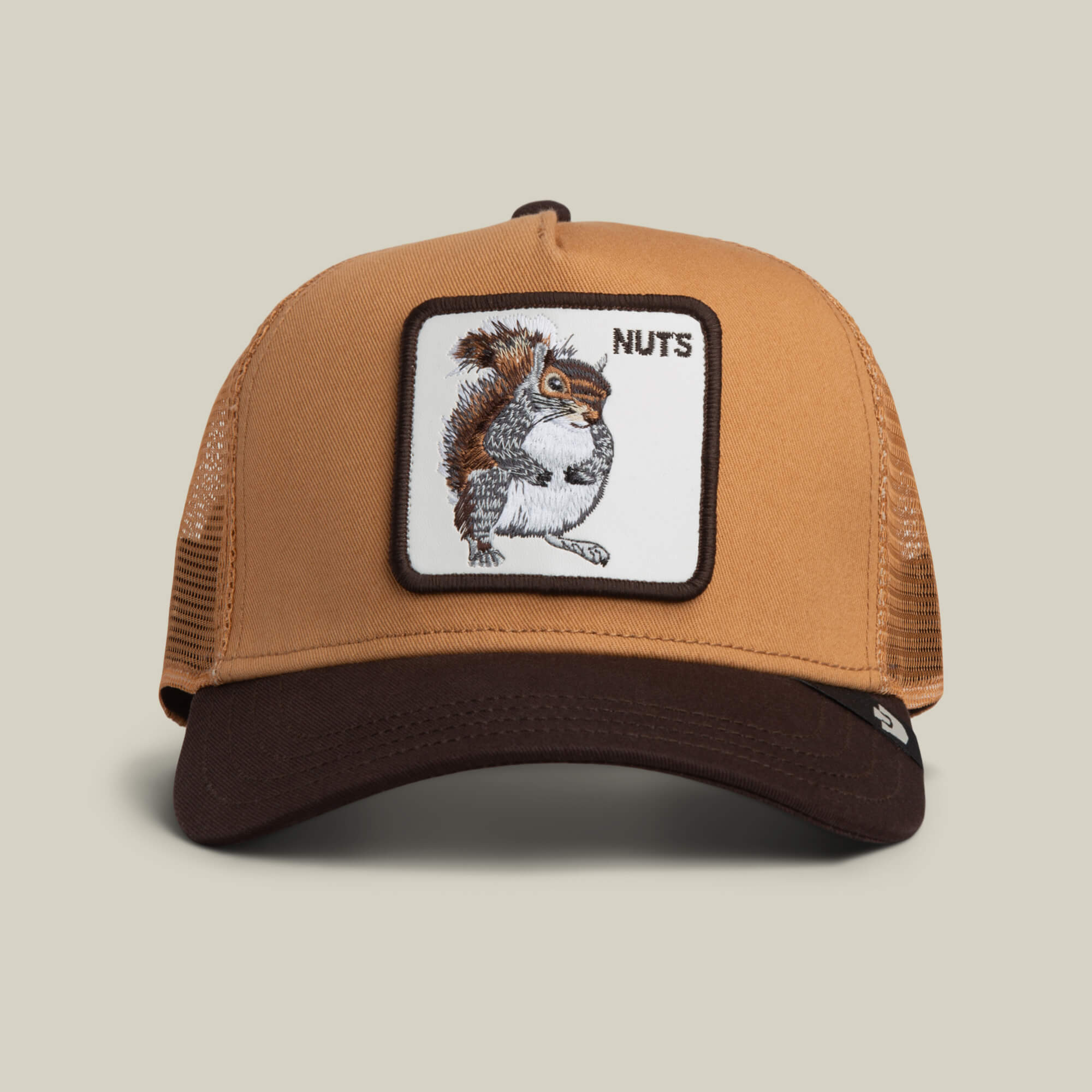 Add playful flair to your look with the Goorin Bros. Nuts Trucker hat in HEAT / GROUND, featuring a squirrel patch and the word NUTS on the front.