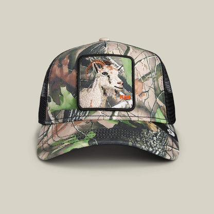 The Goorin Bros. Camouflage Goat hat features a forest camo design, mesh back, and a front patch with an embroidered goat—ideal for outdoor adventures.