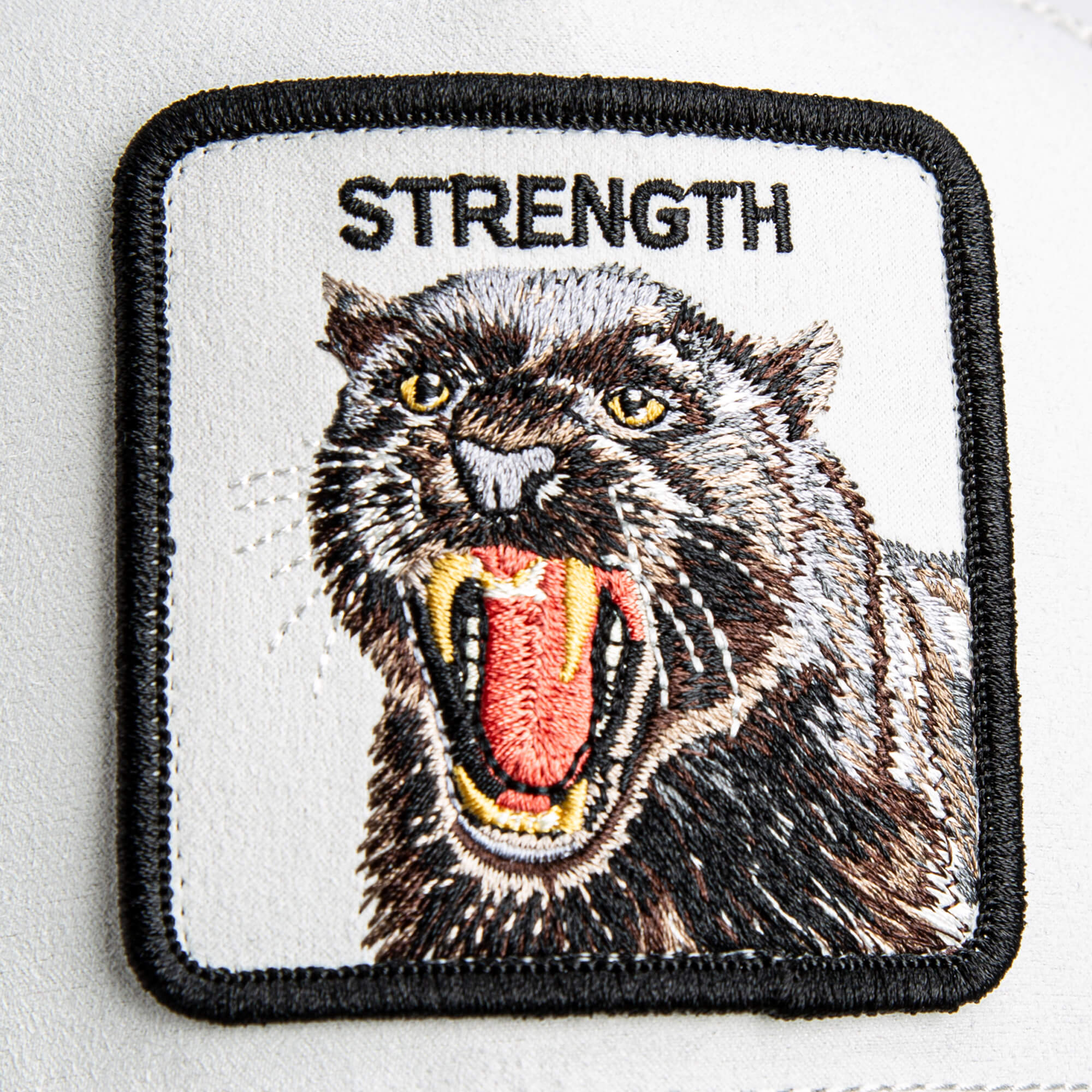 Add bold style to your look with the Suede Panther patch by Goorin Bros., featuring an embroidered snarling panther with "STRENGTH" above it—perfect for customizing your favorite hat.