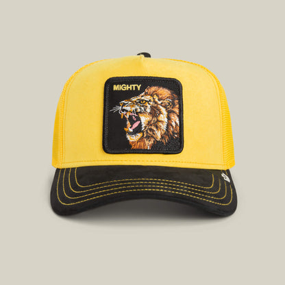 The Goorin Bros. Suede Lion trucker hat features a golden yellow crown, black brim, a lion patch, and MIGHTY embroidered above the roaring lion.