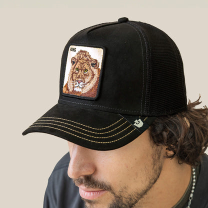 A man wears the Goorin Bros. Golden King black mesh baseball cap, featuring yellow stitching and a KING lion patch, celebrating the golden crown of the jungle.