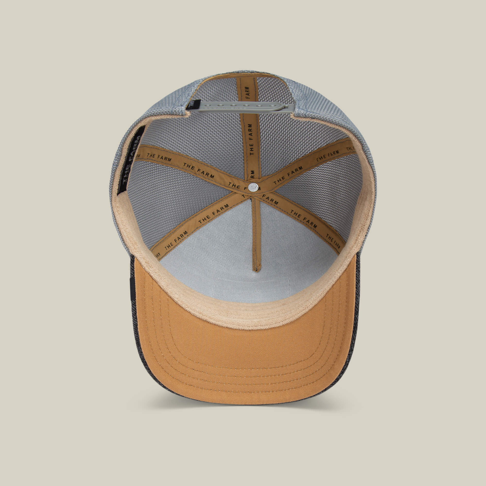 A top-down view of the inside of The Mamba cap by Goorin Bros., featuring tan and black mesh lining, detailed stitching, and an interior band labeled THE LAND—a bold hat crafted for those with a predator mindset.