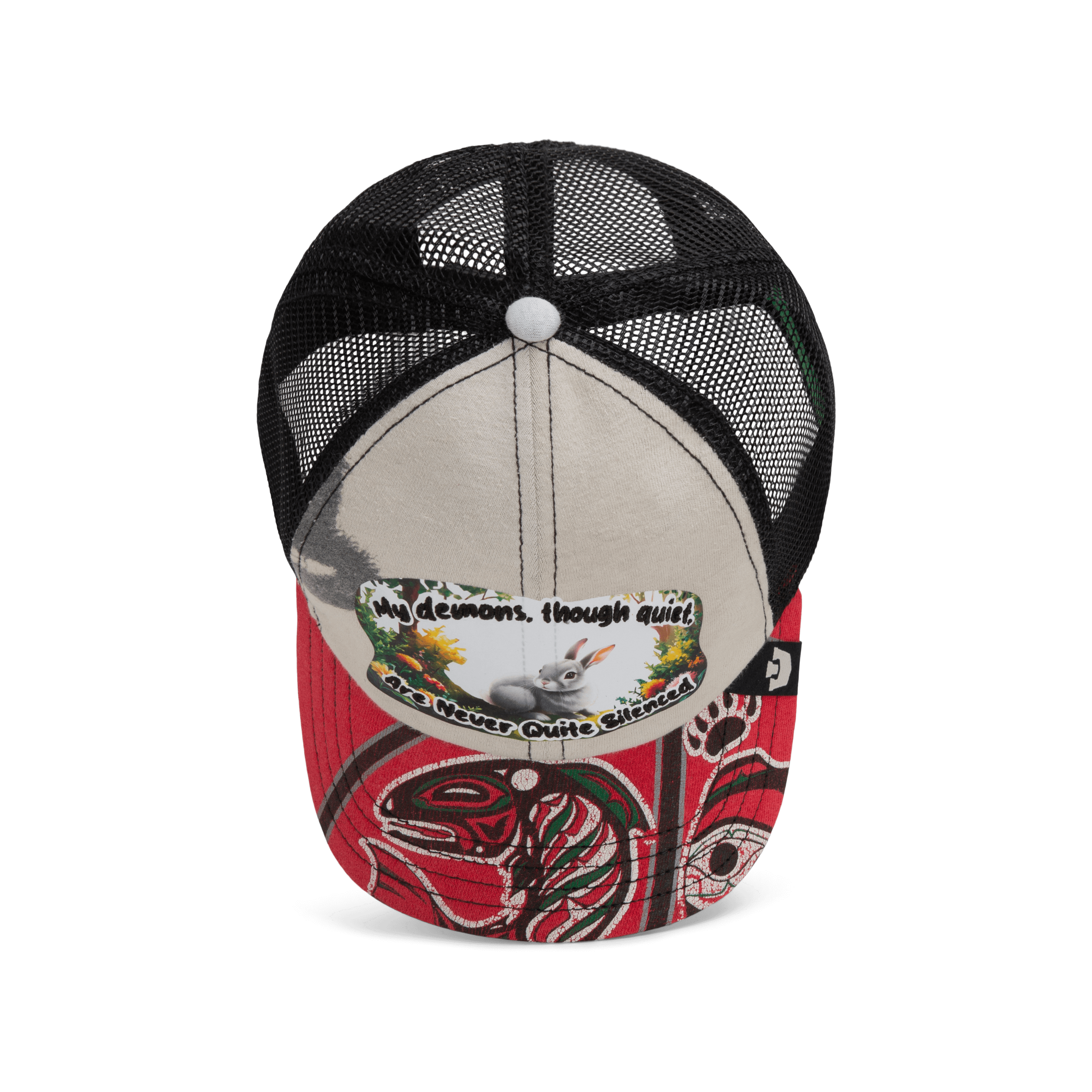 The Goorin Bros. Lil Ronin from the Storybook collection is a black mesh and beige trucker cap with a red brim, featuring Indigenous-style art and a patch that reads, "My demons, though quiet, are never quite silenced.