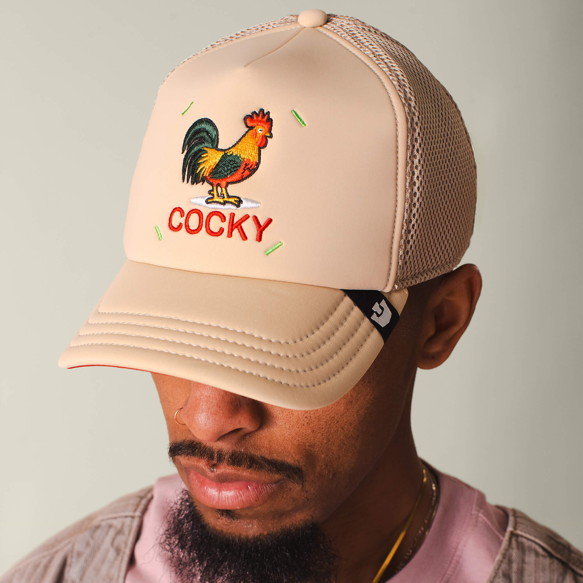 Wearing the Goorin Bros. Neo Farm - Cocky Rooster hat and a pink cocky shirt creates a playful neutral look—ideal for those who love standout farm-inspired style.