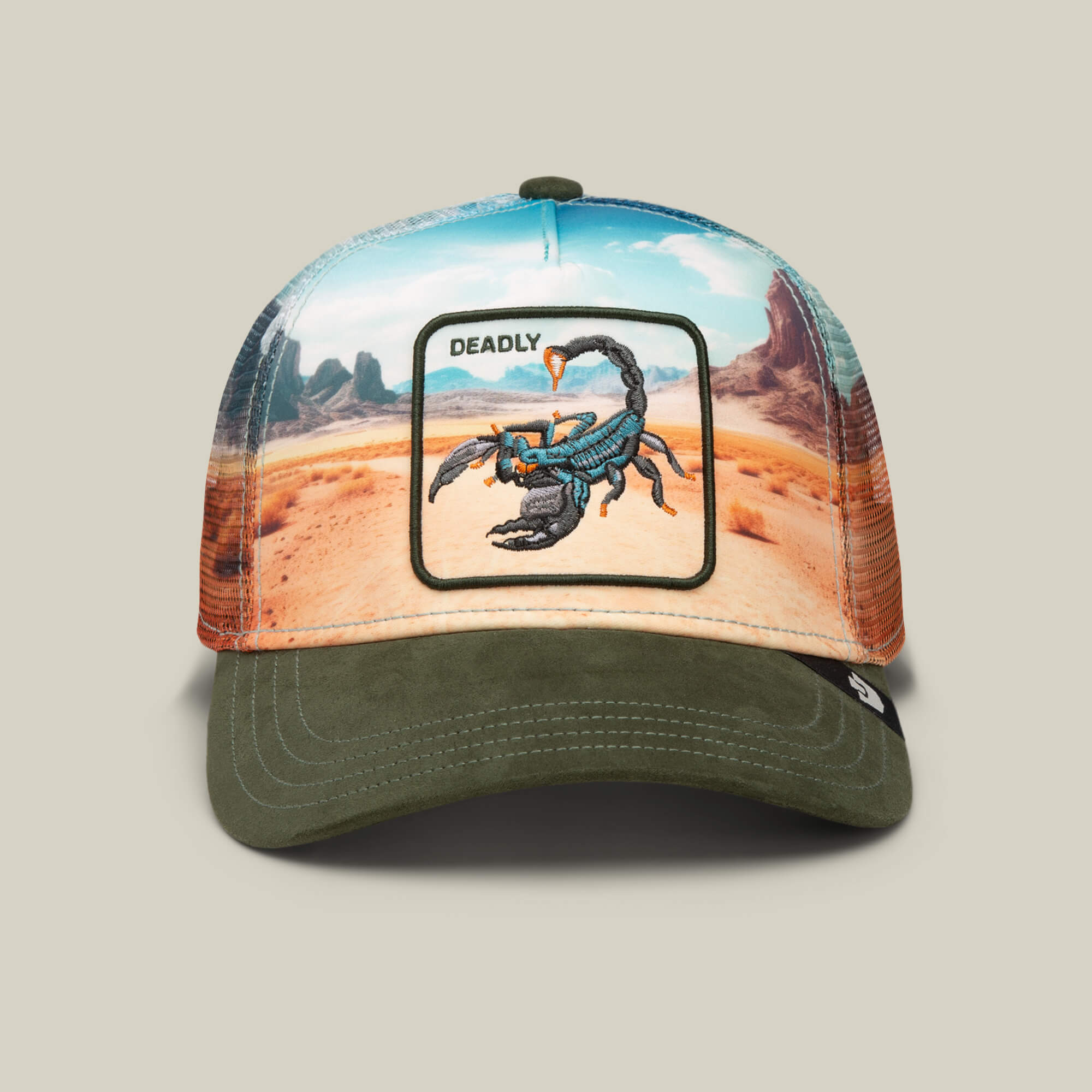 The Goorin Bros. Scorpion In The Element trucker hat in PALM features a desert landscape with a deadly scorpion patch, an olive green bill, and a brown mesh back for cool comfort.