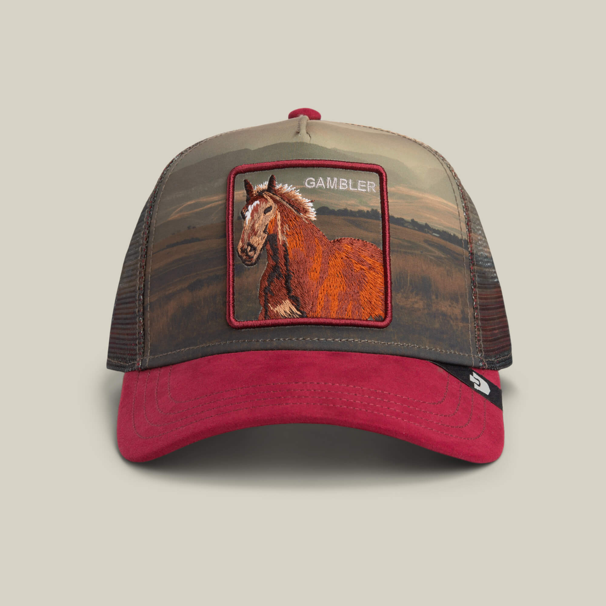 The Goorin Bros. Stallion In The Element hat in CRUSH features a red suede brim, mesh sides, and an embroidered GAMBLER horse patch—ideal for anyone wanting a bold gambler hat style.