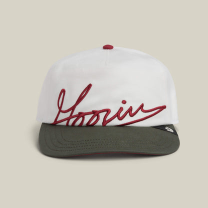 The Goorin Bros. "Goorin Script" cap comes in DUST color, featuring bold red cursive lettering across the front panel.