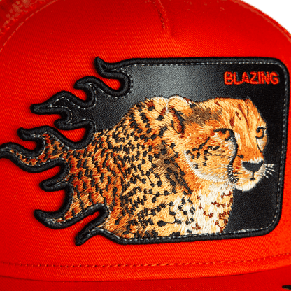 Close-up of the Goorin Bros. Blazing Flames cheetah hat with an embroidered patch featuring flame accents and "BLAZING" in the top right, perfect for trucker hat fans.