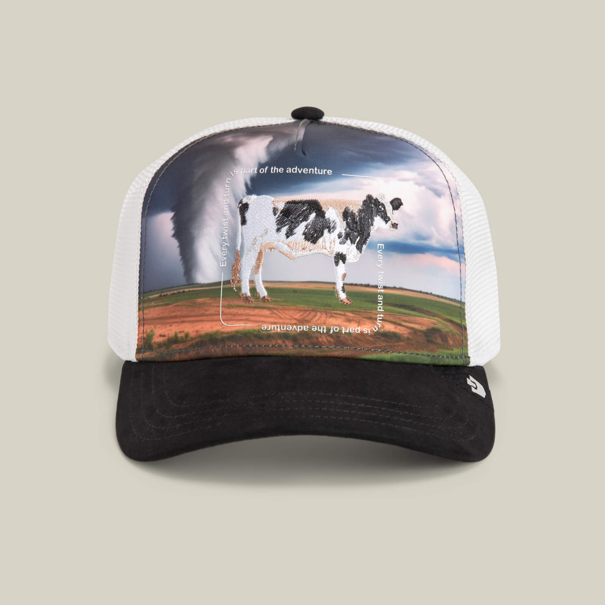 The Goorin Bros. "Through the Storm - Cow" trucker hat in VOID features a cow patch design with a tornado background and the phrase "Be part of the adventure.
