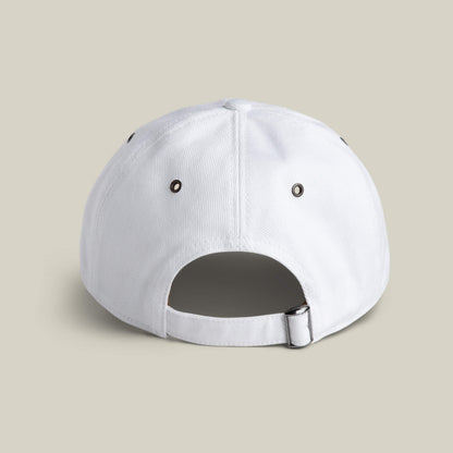 The Goorin Bros. Clean Denim Papa is a classic dad cap in white, shown from the back with a metal buckle and fabric strap for adjustment, plus two black metal eyelets on each side.