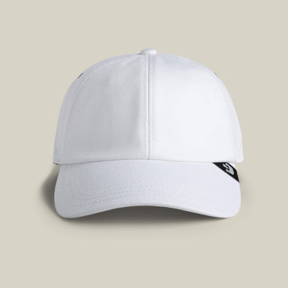 The Clean Denim Papa by Goorin Bros. is a white dad cap with a curved brim, seen from the front, and features a small black tab with a white logo on the right side.