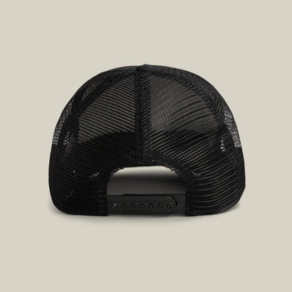 Back view of the Goorin Bros. Clean Denim Trucker hat in black mesh with an adjustable snapback closure, shown against a plain light background.