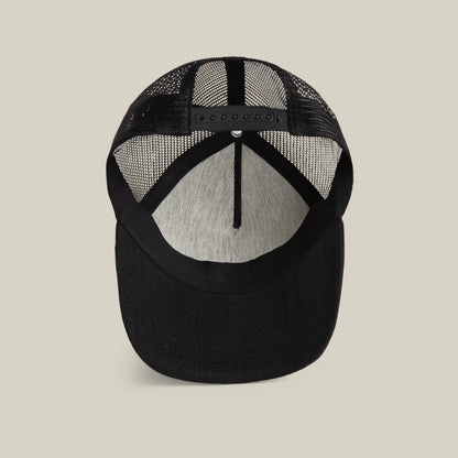 The Goorin Bros. Clean Denim Trucker is a black mesh hat shown from underneath, highlighting its adjustable snapback closure and gray inner lining—designed in the classic denim trucker style.