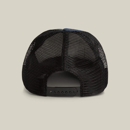 The image shows the back view of the Goorin Bros. Clean Denim Trucker, a black mesh denim hat with an adjustable snapback closure, set against a plain background.