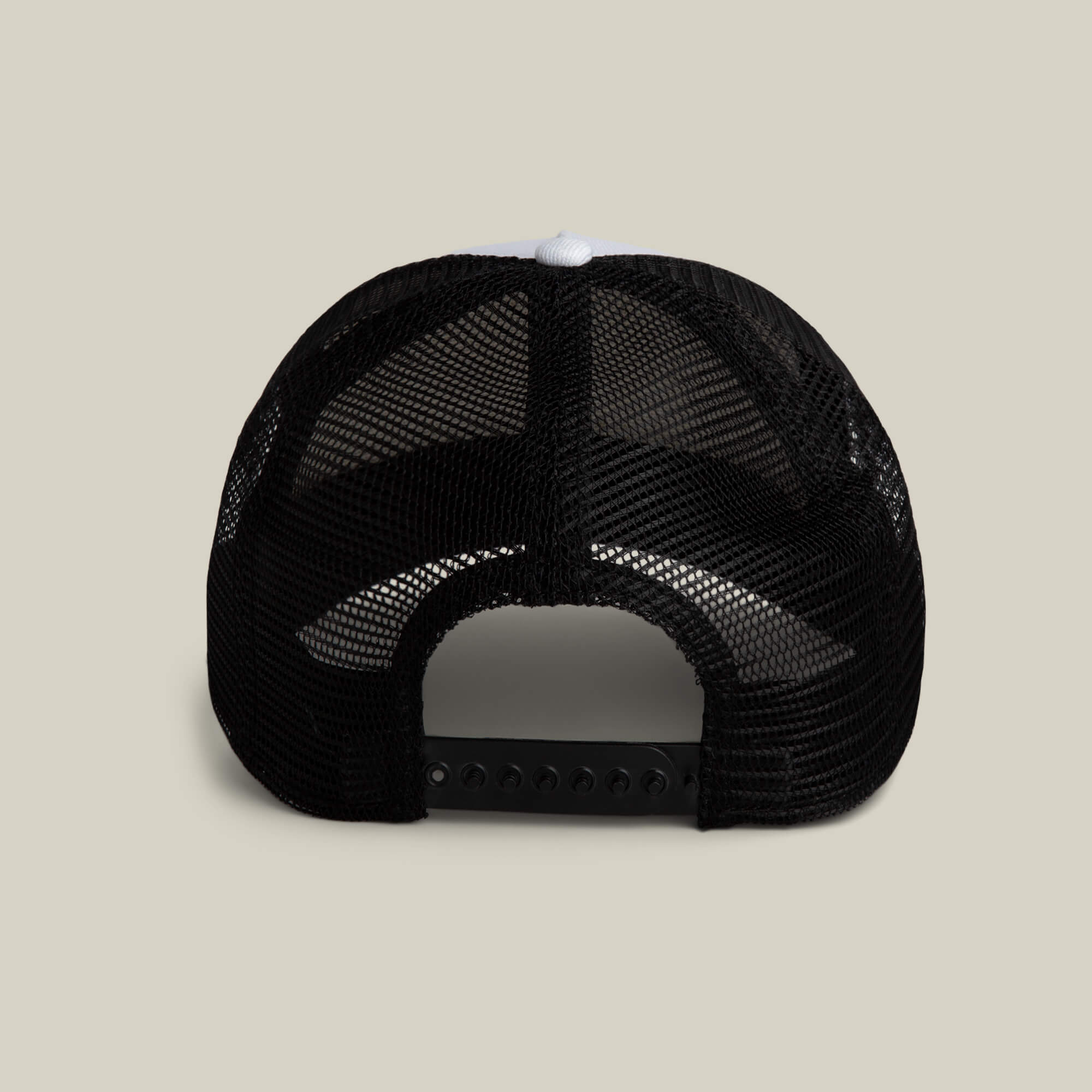 The Goorin Bros. Clean Denim Trucker, a black mesh trucker hat made in the USA, is displayed from the back with an adjustable snapback closure against a plain beige background.