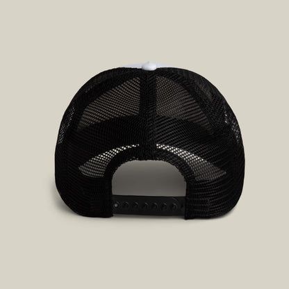 The Goorin Bros. Clean Denim Trucker, a black mesh trucker hat made in the USA, is displayed from the back with an adjustable snapback closure against a plain beige background.