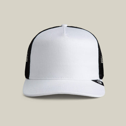 The Goorin Bros. Clean Denim Trucker hat, featuring a white front panel and black mesh back, is displayed against a plain beige background.