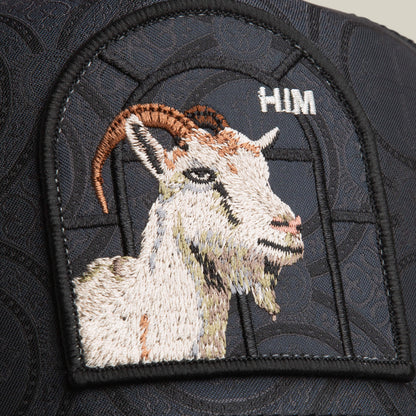 The Goorin Bros. Religulous - Hymn hat features a detailed embroidered goat patch with "HIM" above it, sewn onto a charcoal black cap for a bold statement.