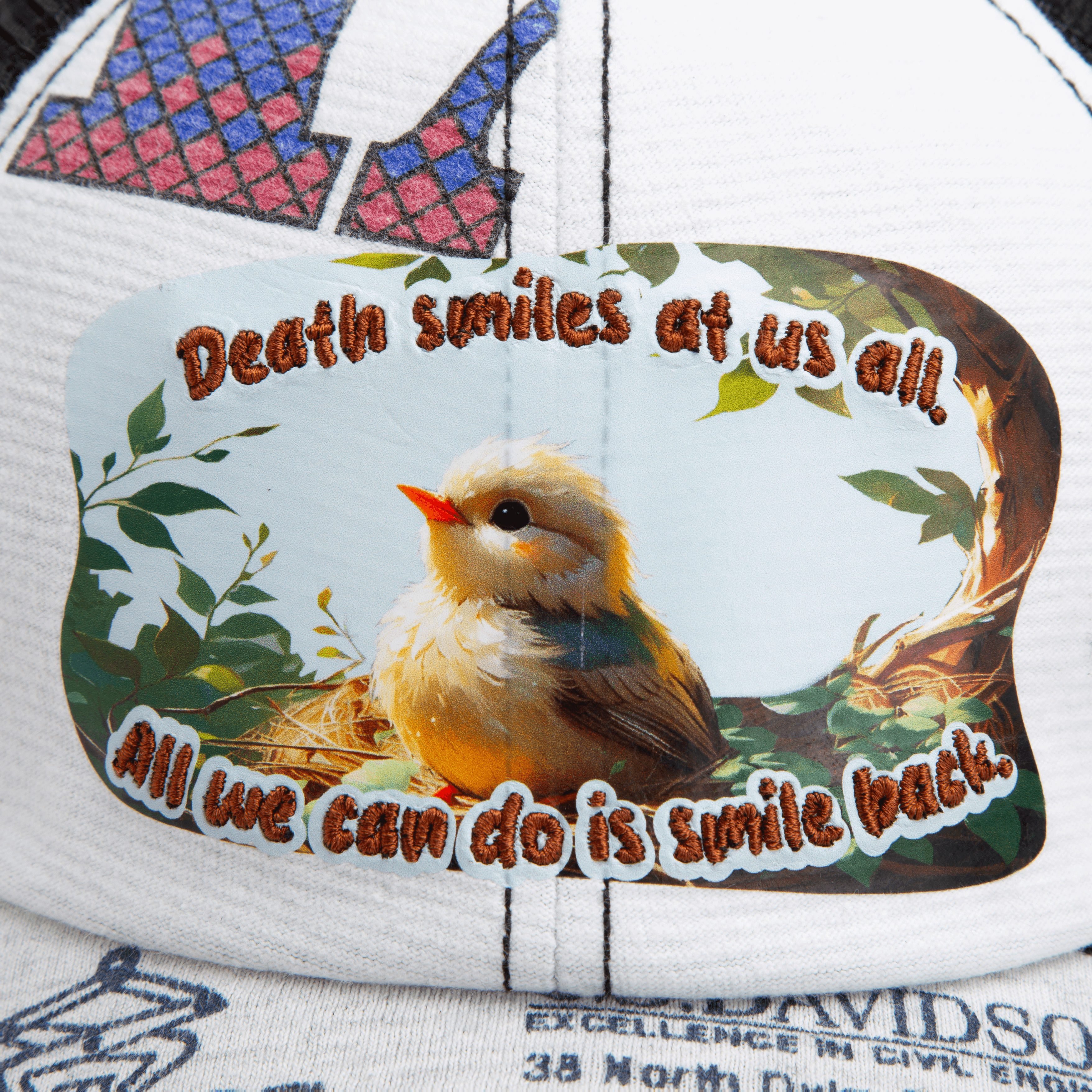A cap from Goorin Bros.' Lil Samurai collection, featuring a patch with a small bird and the text: Death smiles at us all. All we can do is smile back.