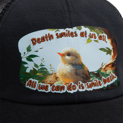 A black Lil Samurai cap from Goorin Bros.' Storybook collection, featuring a fluffy bird in a nest and the text: Death smiles at us all. All we can do is smile back.