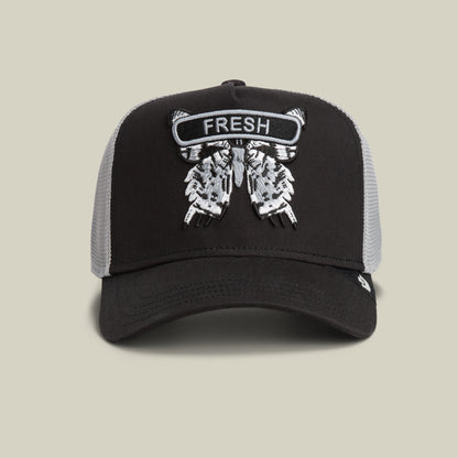 The Goorin Bros. Classic Rocker - Fresh cap in VOID features a detailed embroidered patch with wings and the word FRESH on front—a bold trucker style hat that completes your night mode look.