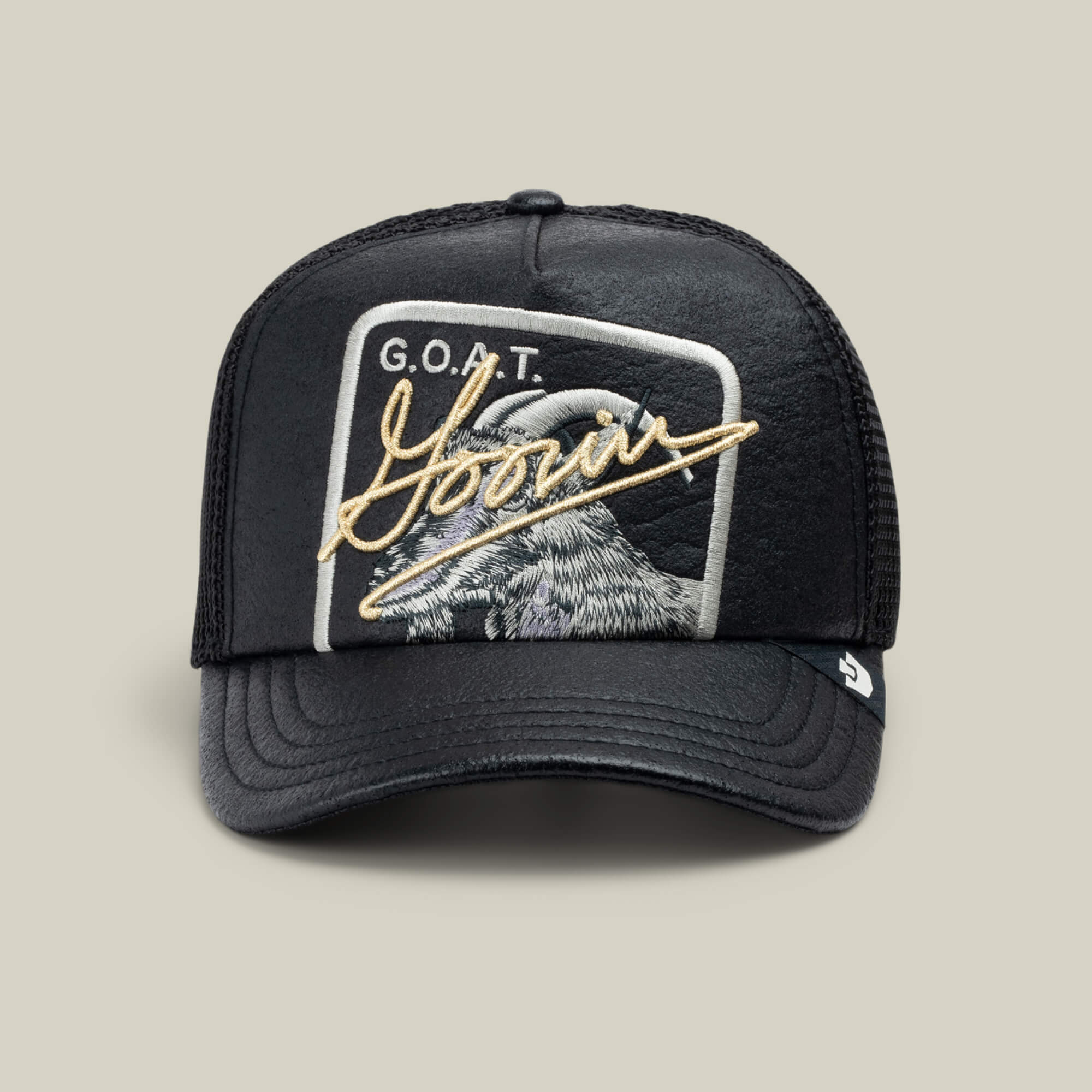The Goorin Bros. NeoBrand GOAT is a black mesh trucker cap with a goat patch, "G.O.A.T." text, and "Yours" in gold script—perfect to pair with your all-black sneakers.