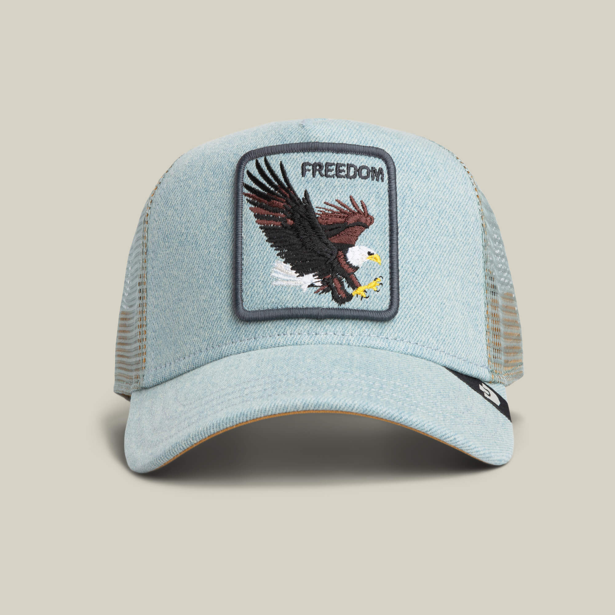 The Goorin Bros. Denim Eagle is a light denim trucker hat with a mesh back, featuring an eagle patch and "FREEDOM" boldly on the front.