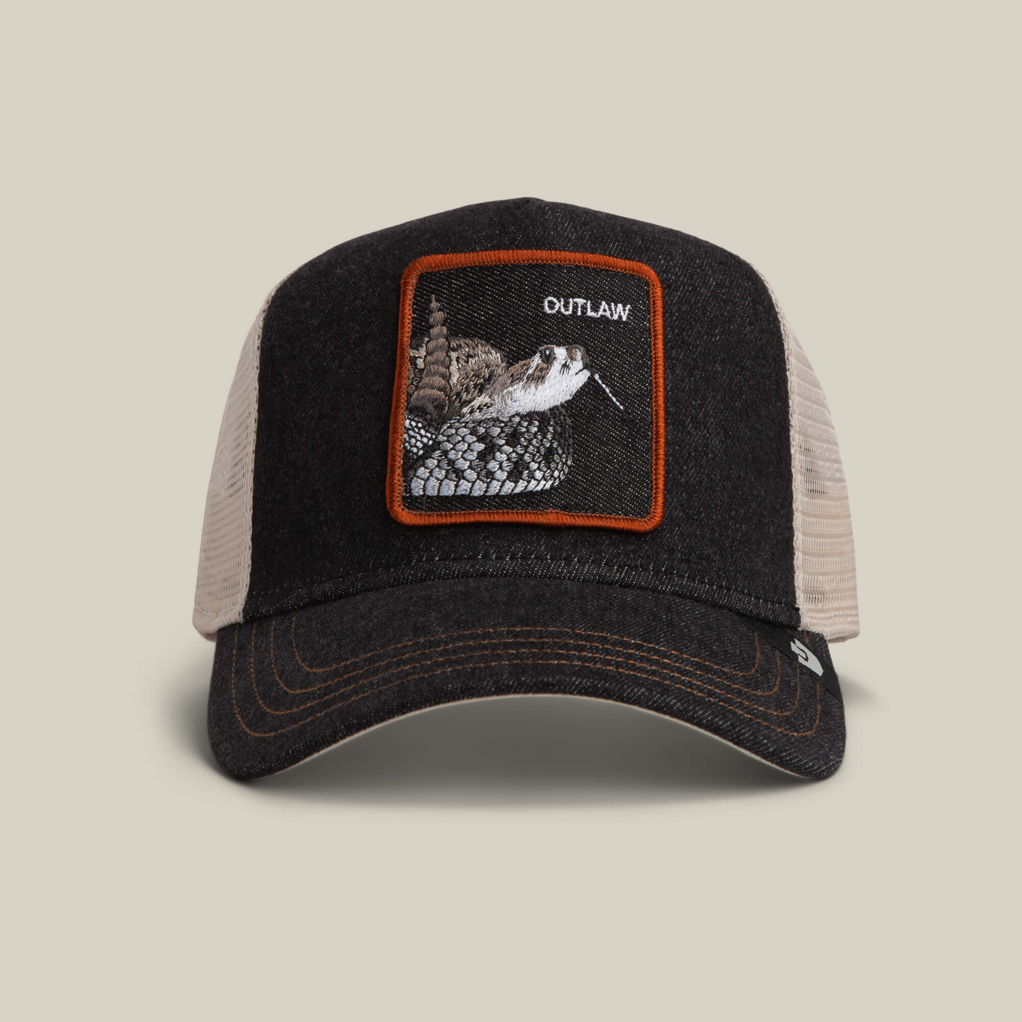 The Goorin Bros. Denim Snake trucker hat in dark denim features a striking rattlesnake patch and the word OUTLAW on the front.