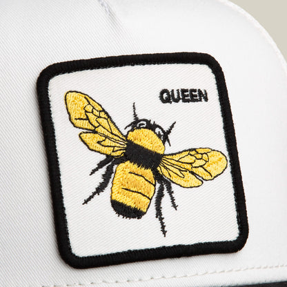 The Goorin Bros. Suede Bee is a white hat with a rectangular Queen patch featuring a yellow and black bee, “QUEEN” text in the corner, and a stylish black microsuede brim.