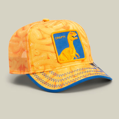 An orange mesh baseball cap with a macaroni pattern, blue zigzag stitching on the brim, and a patch featuring a yellow dinosaur labeled CRAFTY—perfect for fans of bold hat designs and unique trucker hats.