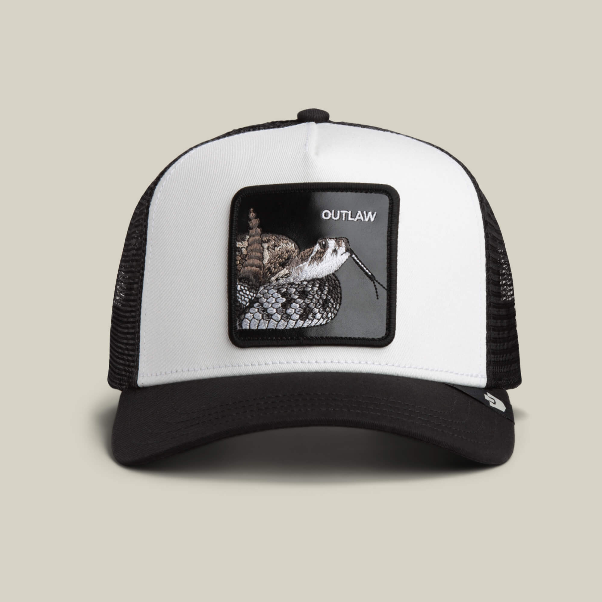 The Goorin Bros. Outlaw Trucker in DUST/VOID features a mesh back, bold rattlesnake patch, and OUTLAW text on the front.