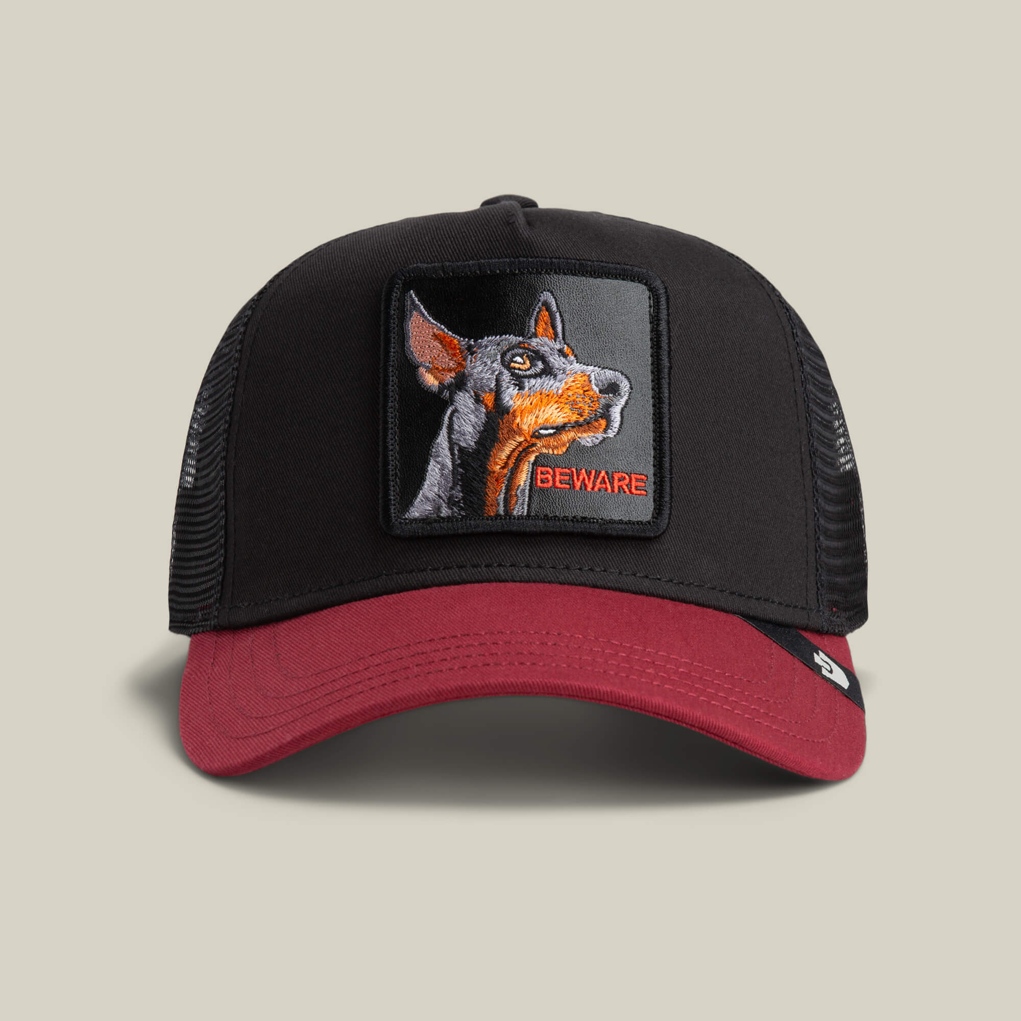 The Beware Dog by Goorin Bros. is a trucker hat in VOID or CRUSH colors, featuring a bold Doberman patch and "BEWARE" embroidered on the front.