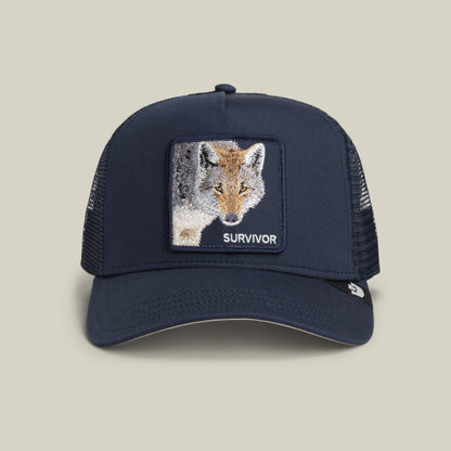 The Mirage Survivor by Goorin Bros. is a trucker hat in EDGE color, featuring a mesh back and a rectangular patch with an embroidered fox and "SURVIVOR" on the front—perfect for standout survivor style.