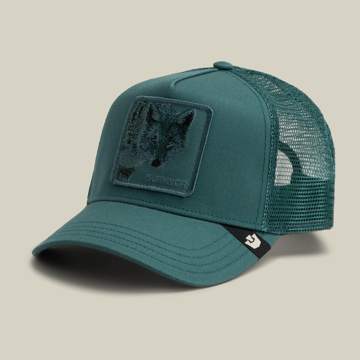Teal Goorin Bros. Mirage Survivor trucker hat featuring a rectangular wolf patch with the word SURVIVOR embroidered on the front.