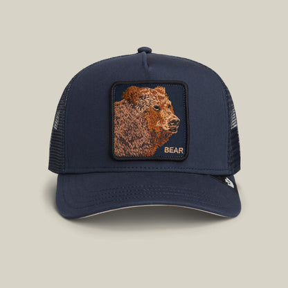 The Goorin Bros. Bear Trucker hat in EDGE features a mesh back and a front patch with an embroidered bear and "BEAR" in gold letters.