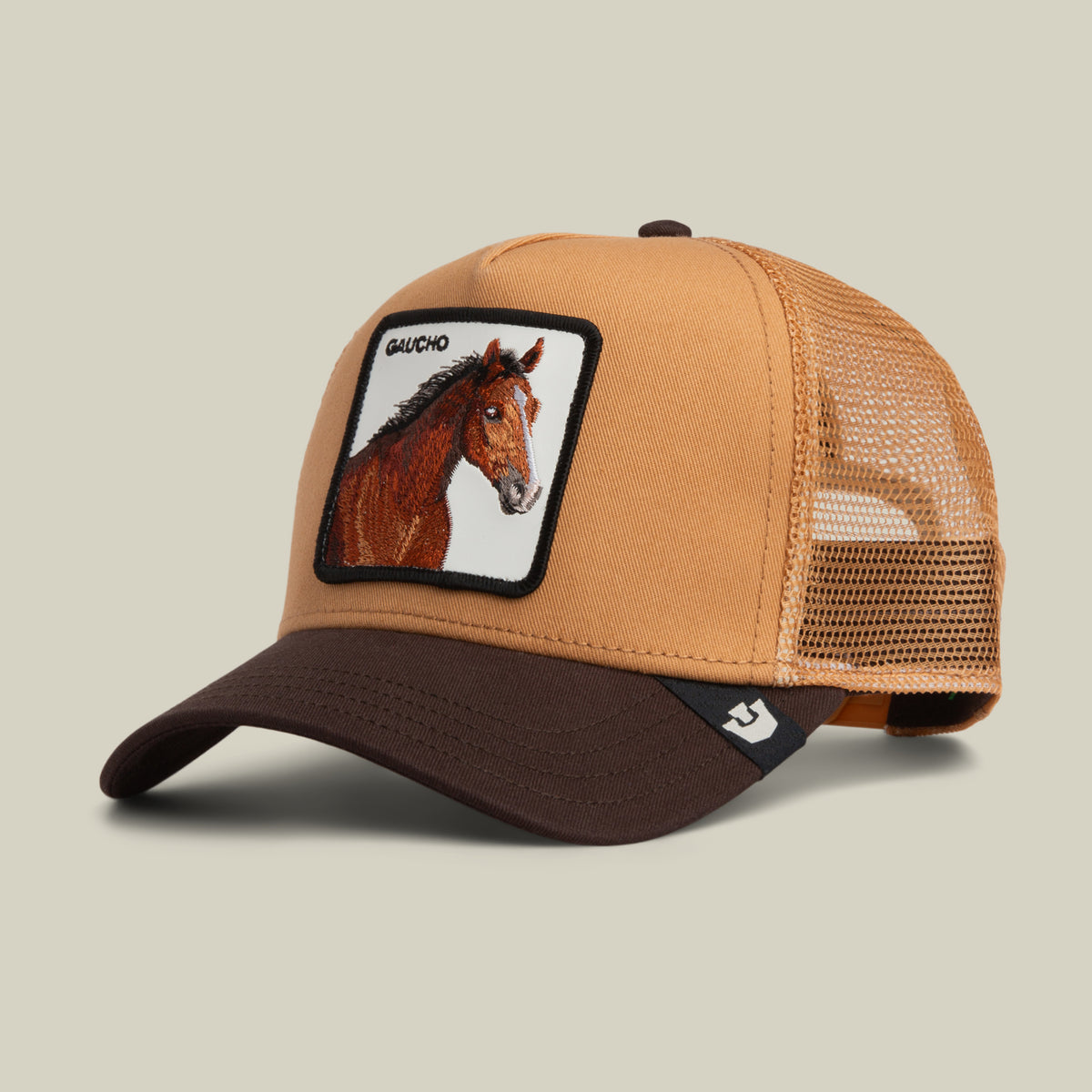 Tan and brown Gaucho Trucker hat in an earthy colorway with a patch featuring a horse and the word GAUCHO.