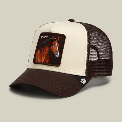 Brown and cream Gaucho Trucker hat featuring an embroidered horse patch with the text GAUCHO above the image.