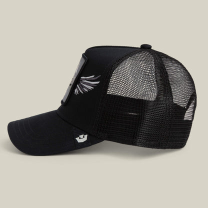 The Wings Legend trucker hat by Goorin Bros. features black mesh, a curved brim, side wing embroidery, and a striking front patch with a Pegasus graphic. Adjustable at the back and shown against a plain light background, this statement piece blends classic design with mythical style.