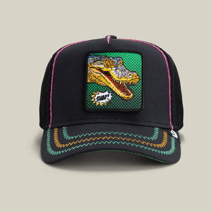 The Goorin Bros. "Crackle and Pop, Brother" trucker hat in VOID features a colorful embroidered dinosaur patch and neon stitching on the brim, bringing a bold Pop Art touch.