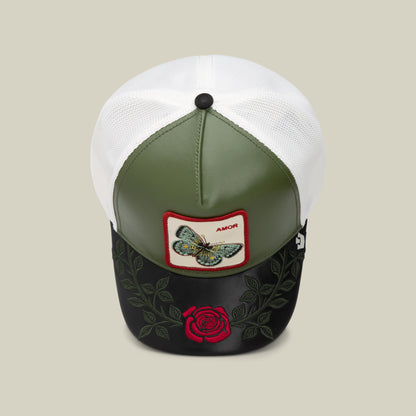 The Amor cap by Goorin Bros. features a green and black front, white mesh back, butterfly patch labeled "AMOR," and embroidered roses on the brim—perfect to pair with your favorite AMOR jewelry or love necklace.